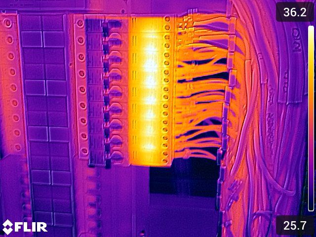Thermal image of a glowing connection column on a distribution board