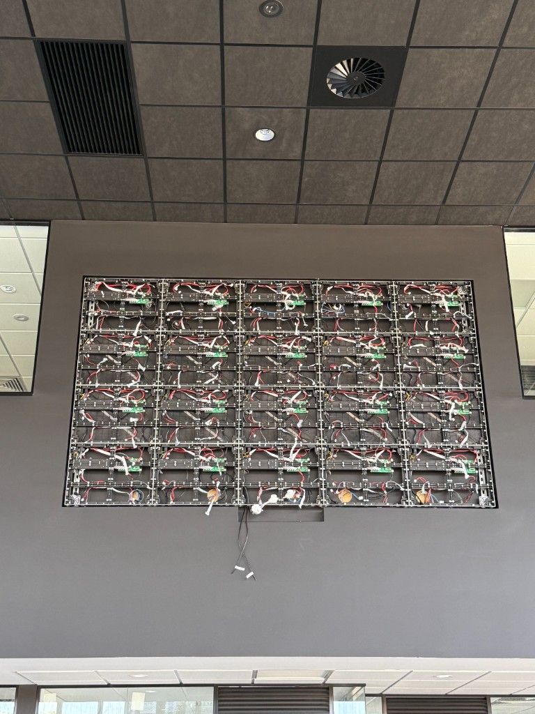 Indoor video wall during fit-out, with modules, controllers, and wiring in place